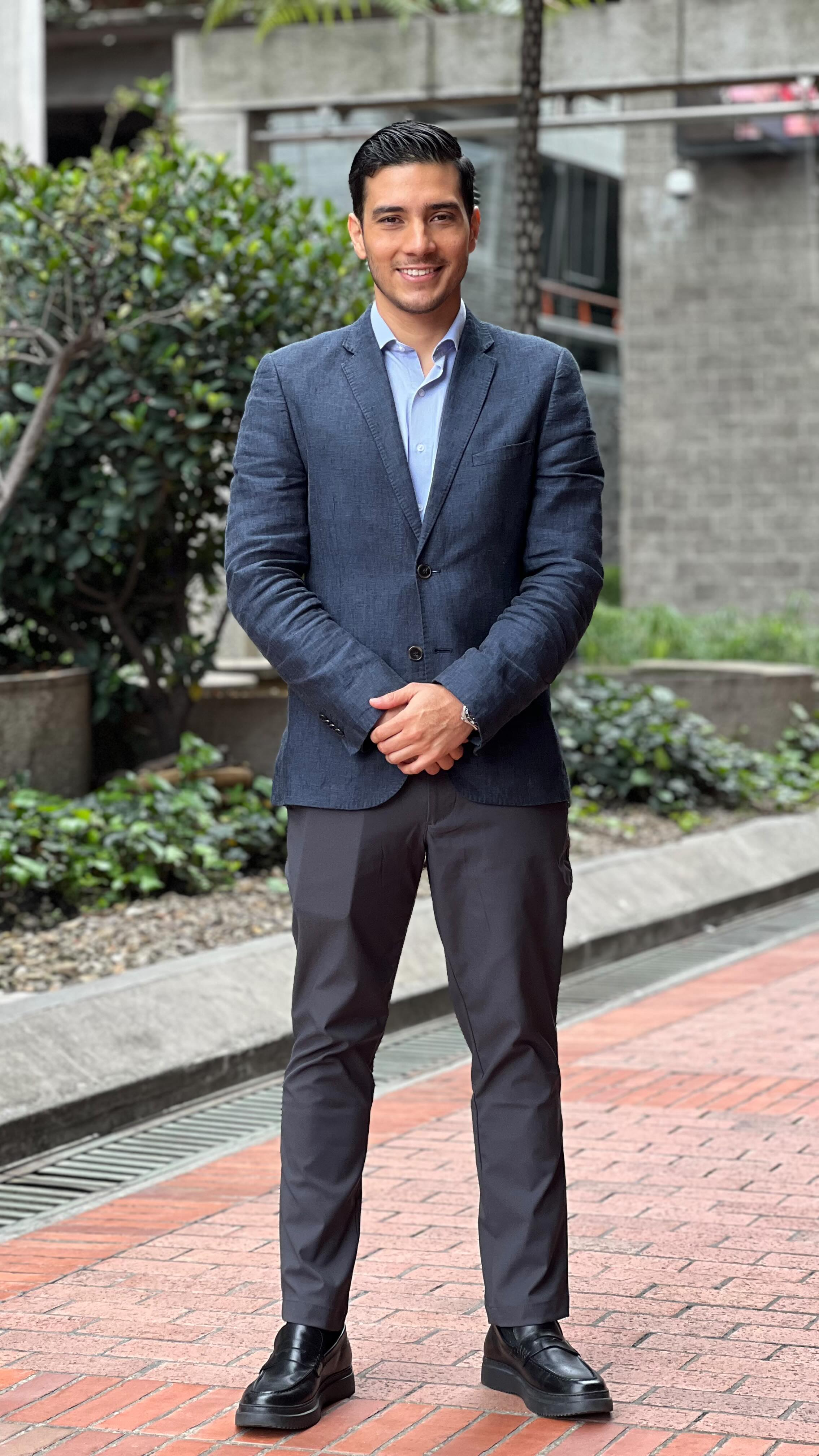 Dr. Manuel in a suit outdoors